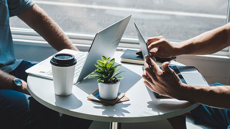 two laptops on the table at a coffee shop