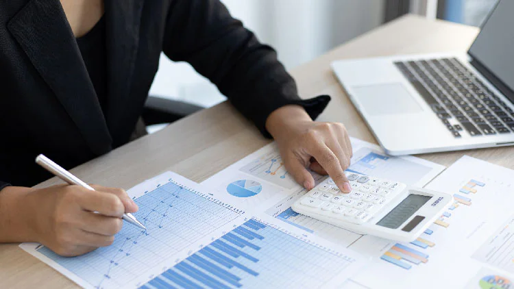 a woman calculating financial report