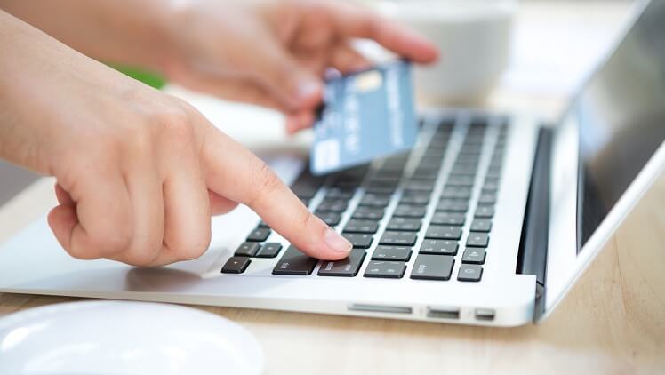 entering bank account, credit/debit card information by using a laptop
