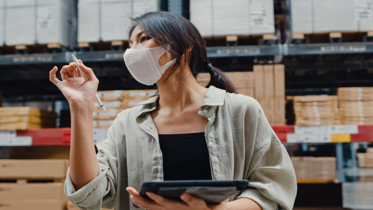 woman with mask working in warehouse